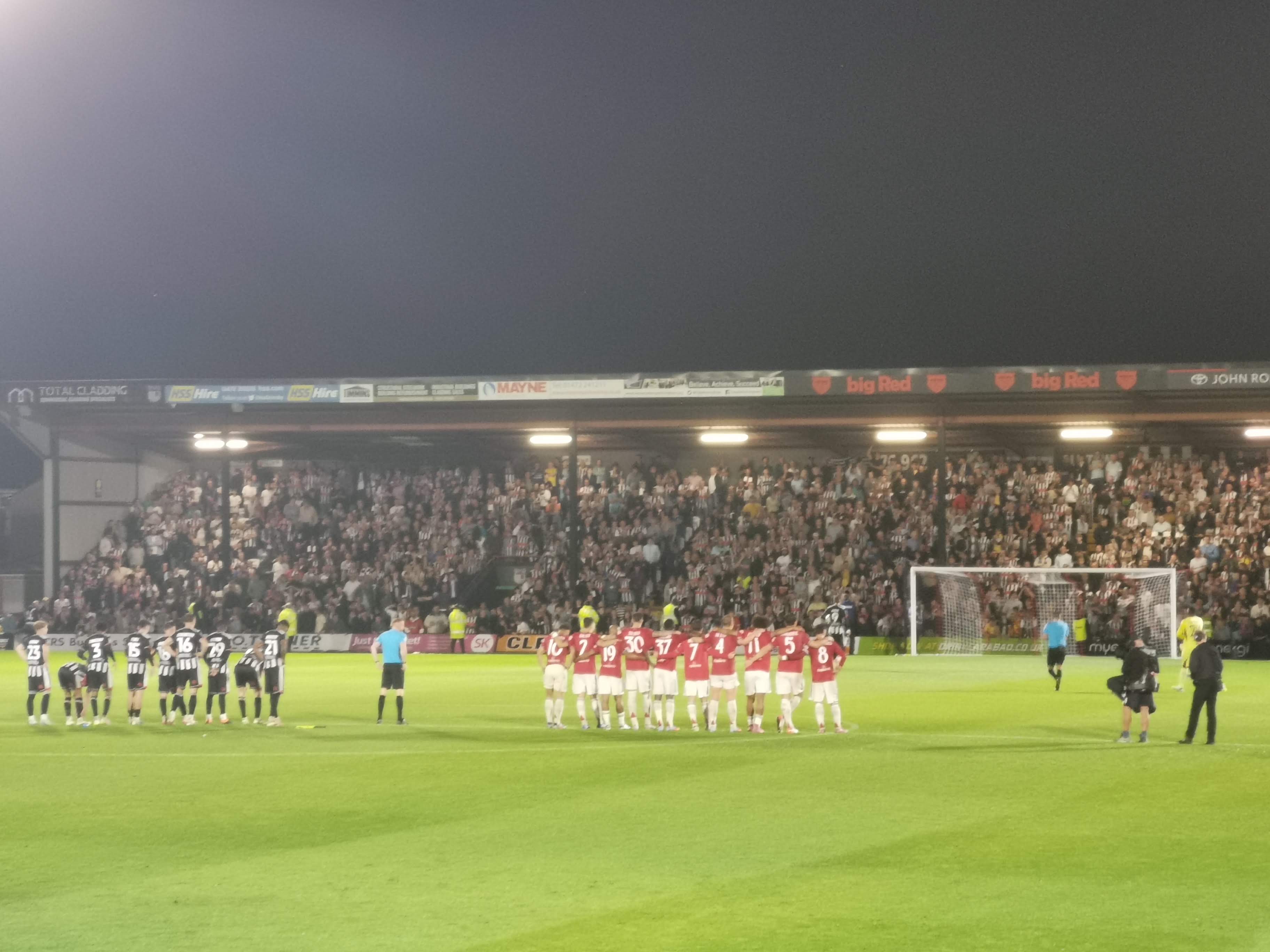 Grimsby Town and Manchester United players line up for penalties