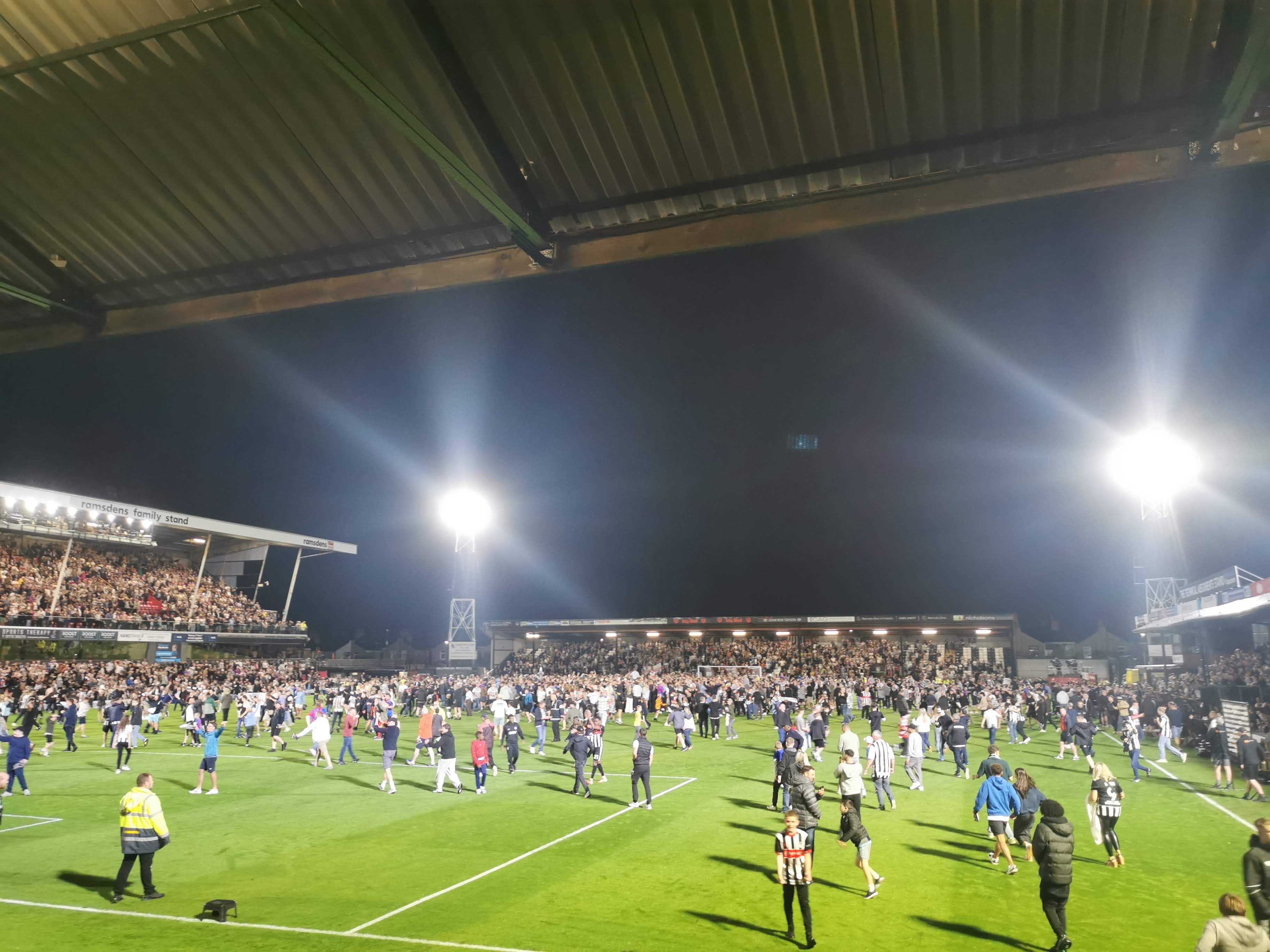 Grimsby Town fans invade the pitch after the victory over Manchester United