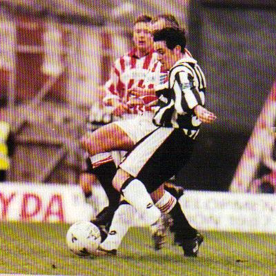 Grimsby Town player David Smith shoots towards goal in a 1998 match against Brentford.